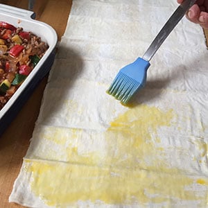 Brush each sheet of filo with oil. Brush each sheet of filo with oil.