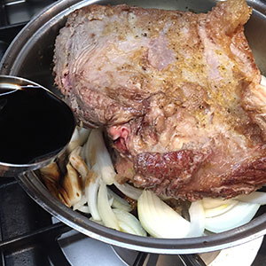 Place the onions around the meat then add the sherry vinegar. Place the onions around the meat then add the sherry vinegar.