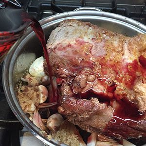 Pour in the red wine and stock. Pour in the red wine and stock.