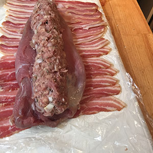 Place the stuffing down the centre of the tenderloins. Place the stuffing down the centre of the tenderloins.